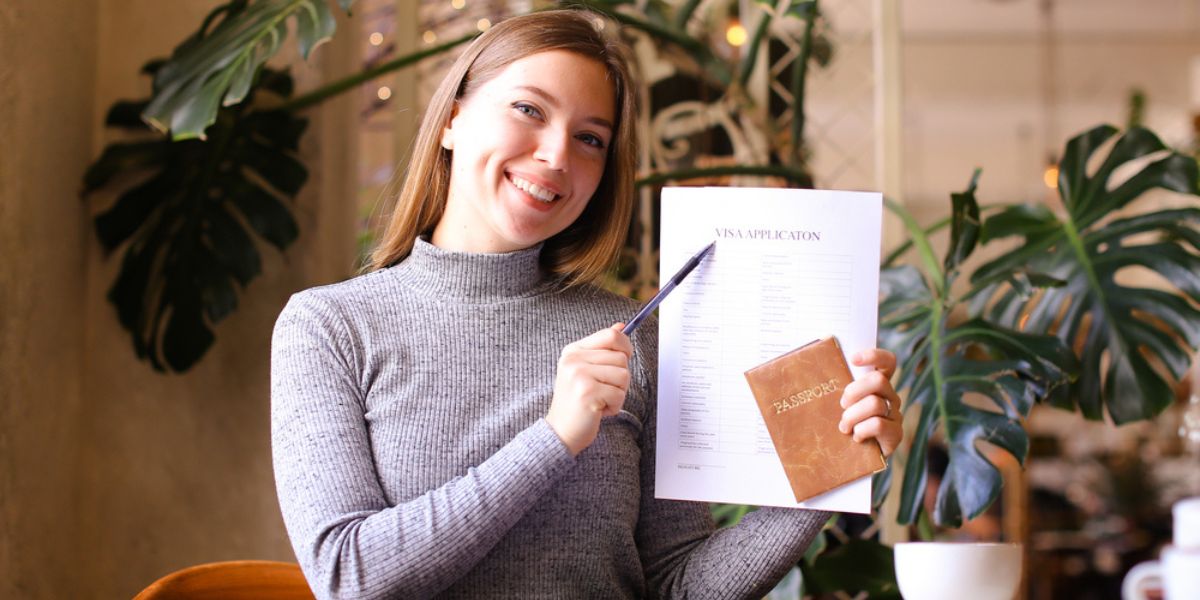 girl holding visa application